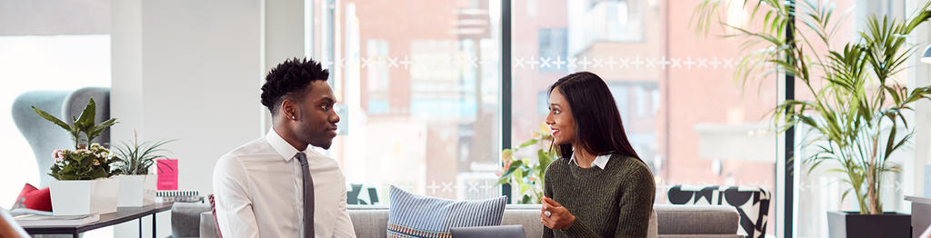 Two professionals engaged in a virtual interview conversation in a bright modern office