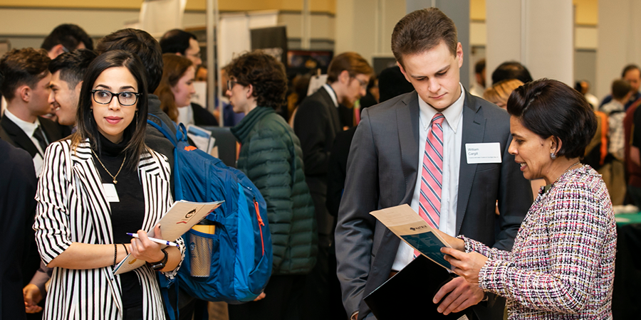 Job seekers converse with employers at Mason's Career Fair