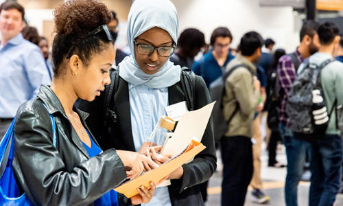 Two students meet at Mason's Spring Career Fair